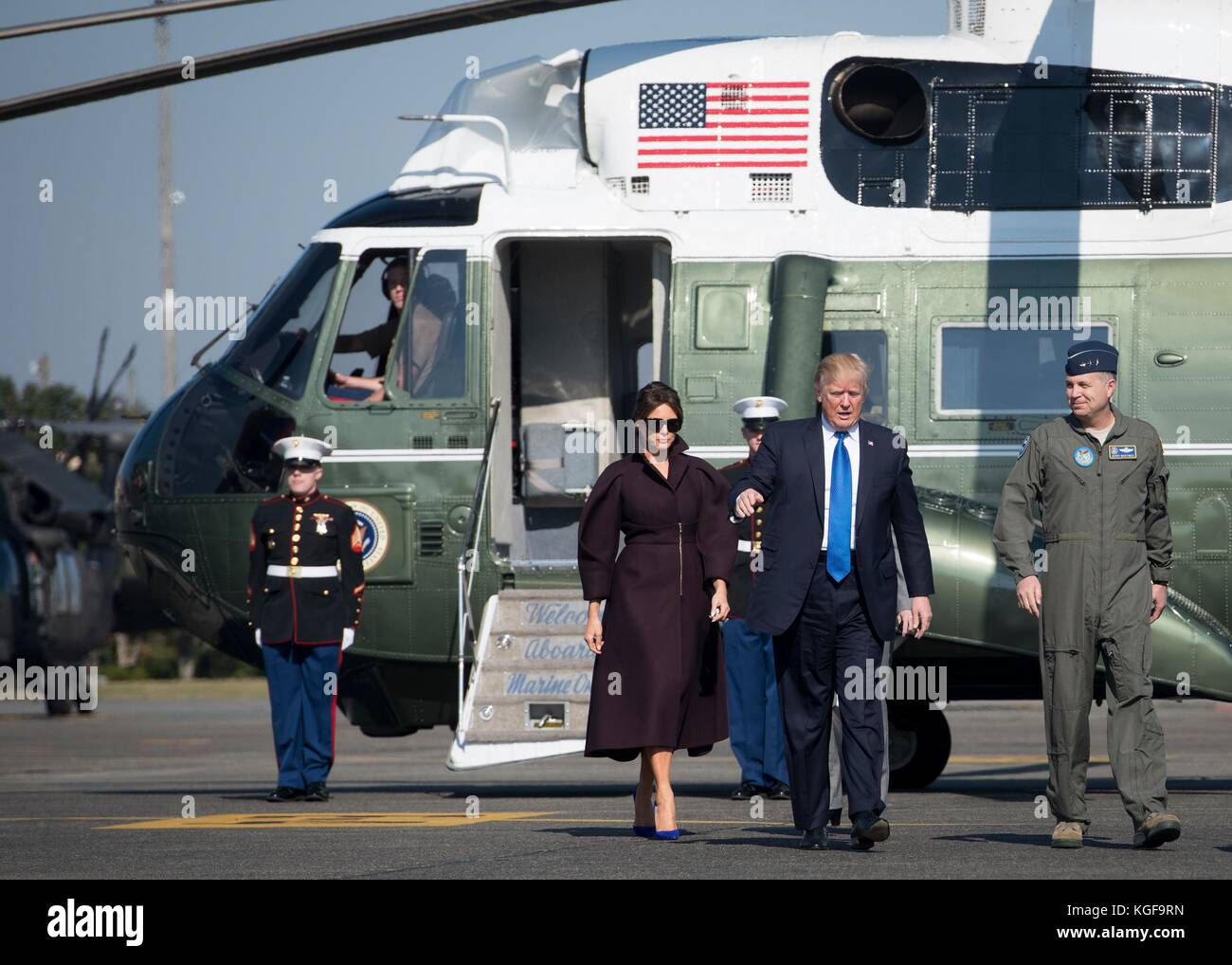 Fussa, Japan. 07th Nov, 2017. U.S President Donald Trump walks with First Lady Melania Trump as he speaks to Lt. Gen. Jerry P. Martinez, U.S. Forces Japan and 5th Air Force commander, before boarding Air Force One at Yokota Air Base November 7, 2017 in Fussa, Japan. Trump completed a three-day visit to Japan, the first stop of a 13-day swing through Asia. Credit: Planetpix/Alamy Live News Stock Photo