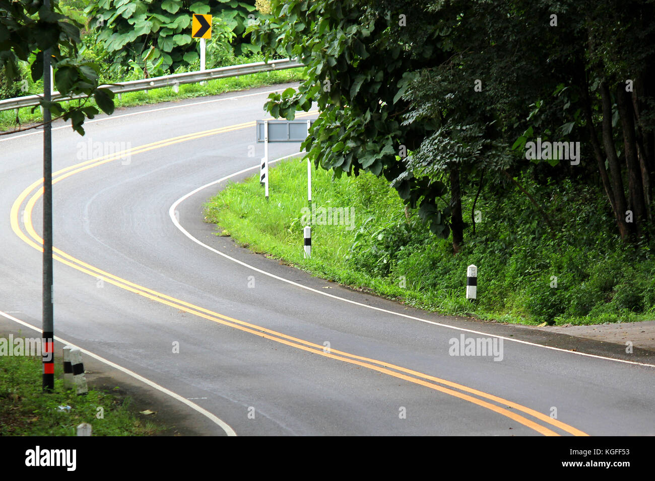 curves road in countryside with tropical green forest Stock Photo