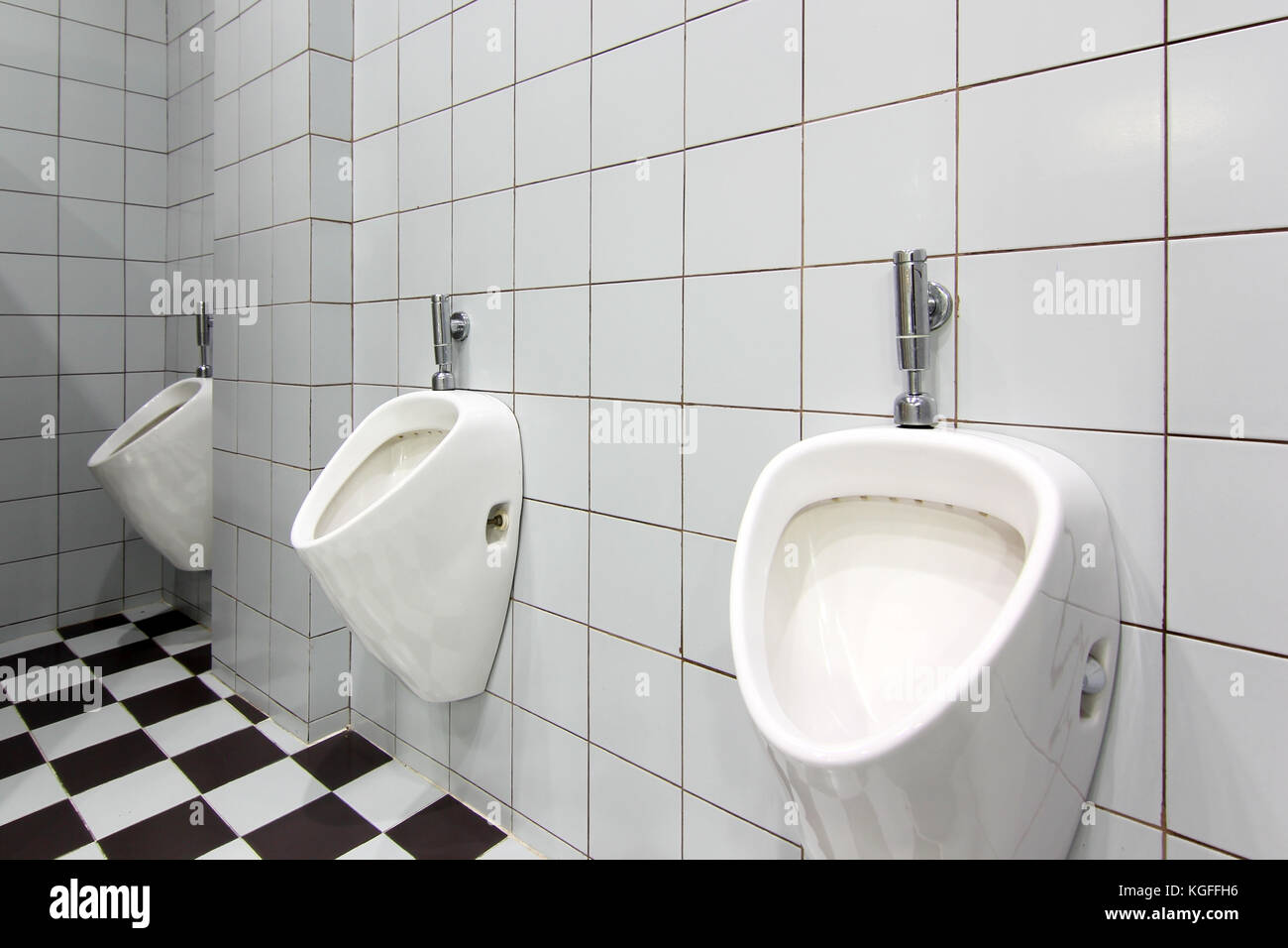 line of white urinals in public toilet Stock Photo Alamy