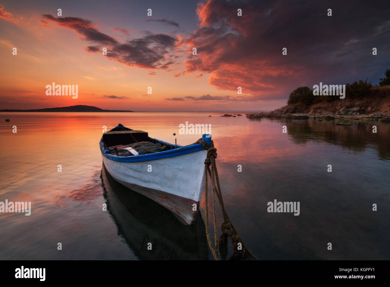 Lonely boat at sunset Stock Photo - Alamy