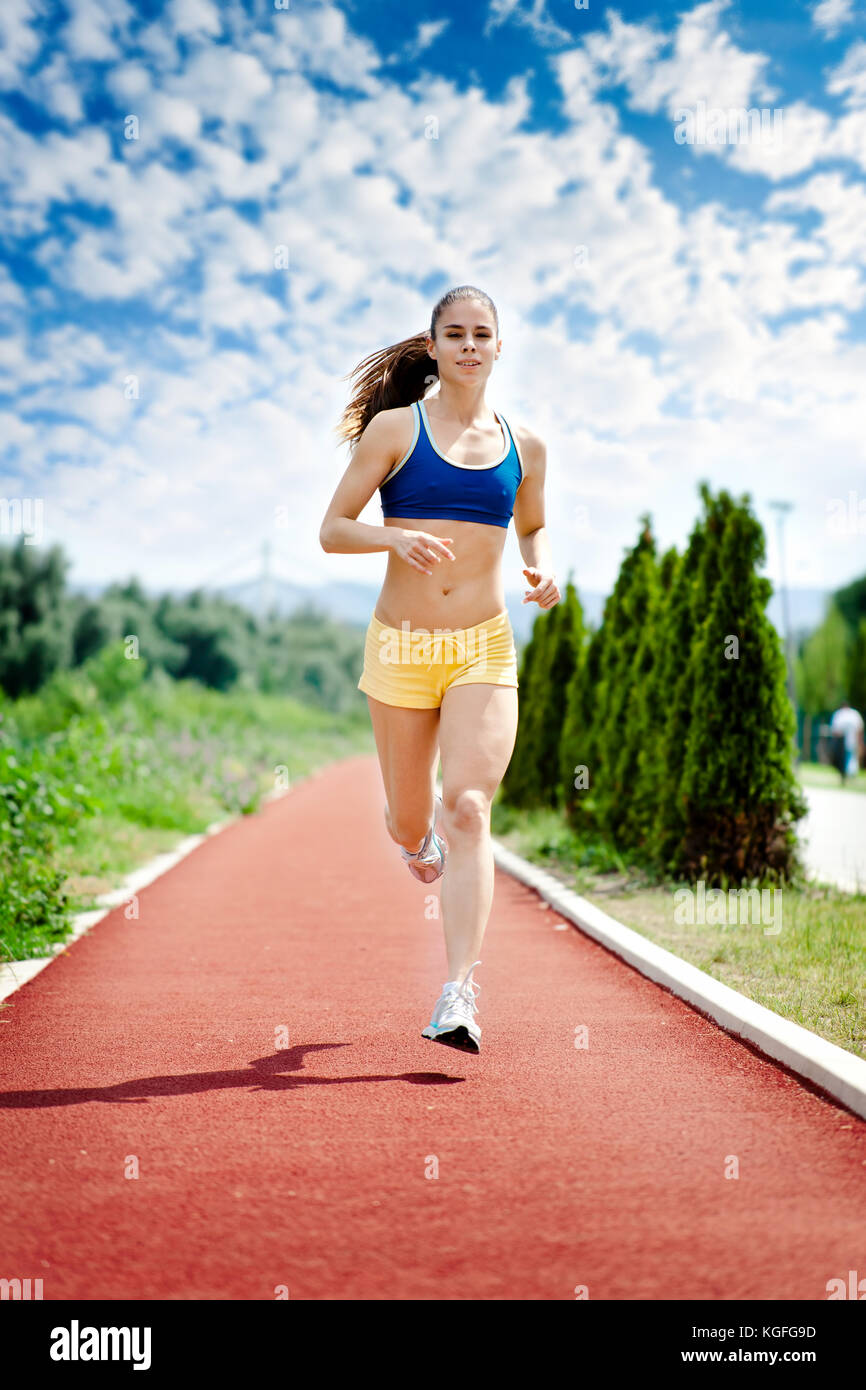 runner - woman running outdoors training for marathon run. Beautiful  fitness model in her 20s Stock Photo - Alamy