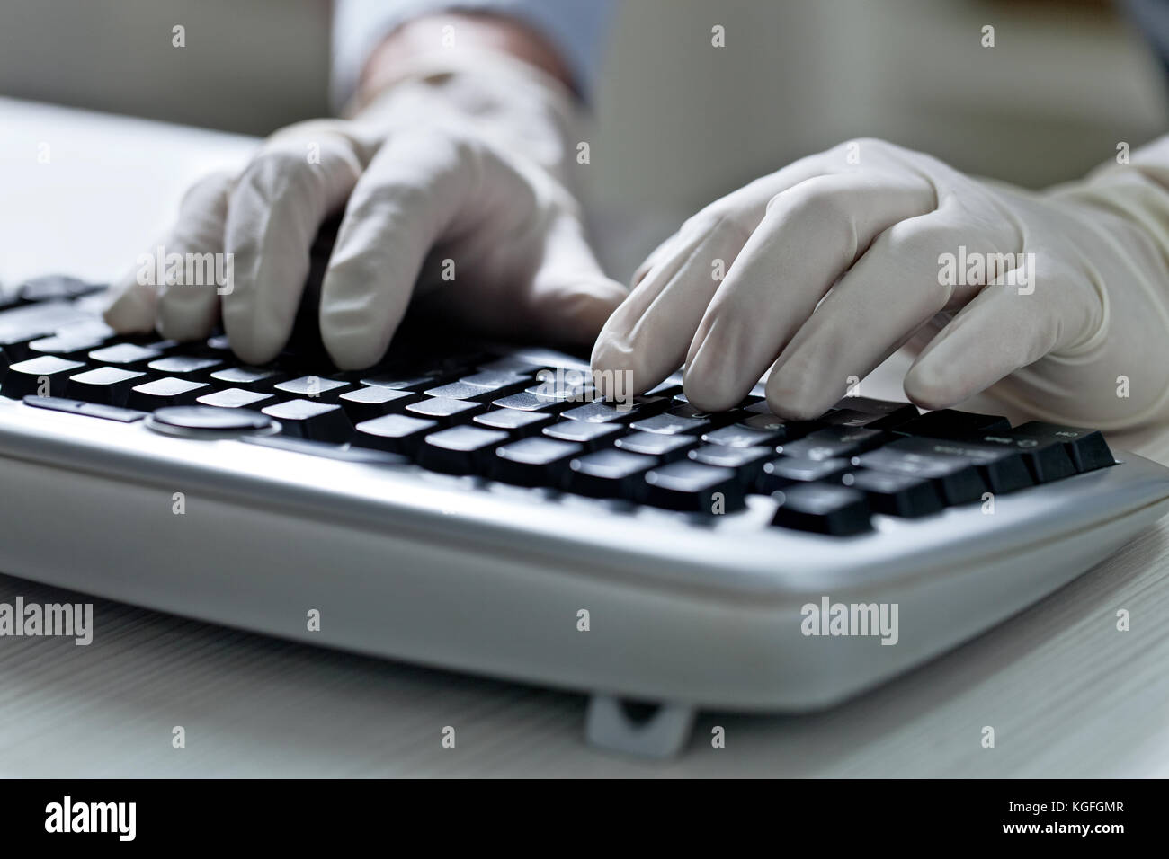 Computer hacker hand in glove working on laptop Stock Photo - Alamy