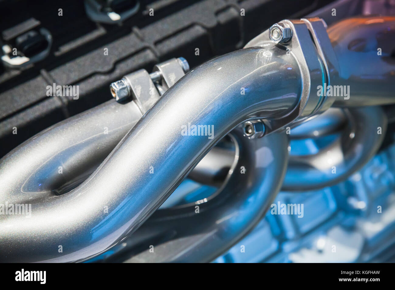 Air blowing tubes. Shiny motor parts, automotive V12 engine fragment, closeup photo with selective focus Stock Photo