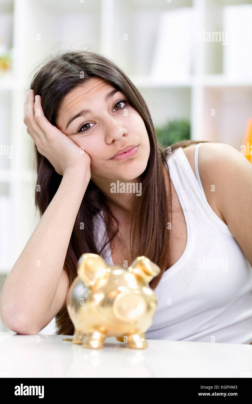 Unhappy teenager girl with her empty piggy bank Stock Photo - Alamy