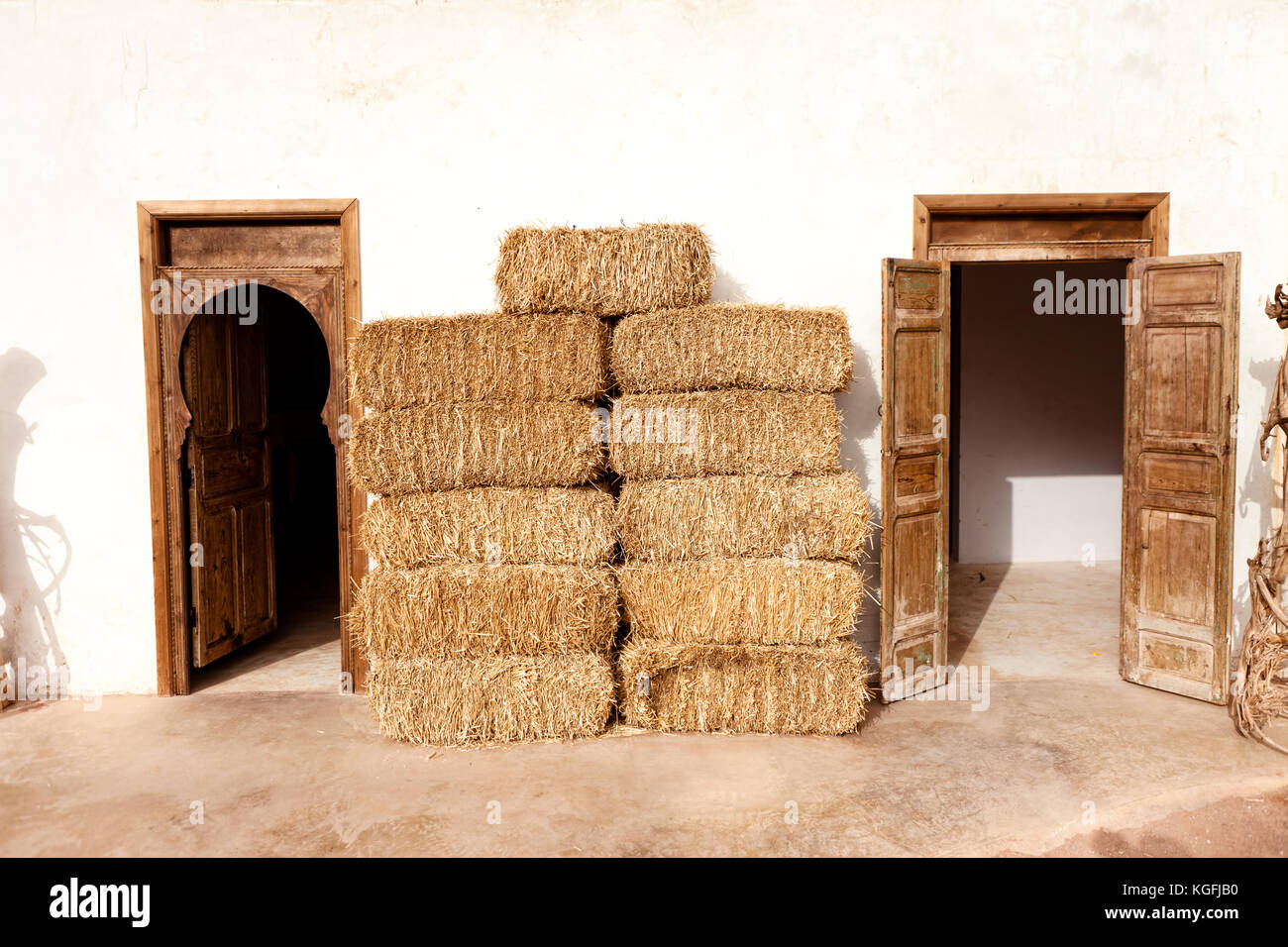 Old authentic Moroccan home with straw bales next wall Stock Photo