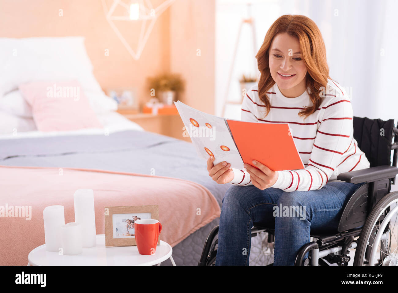 Cheerful disabled woman reading in the wheelchair Stock Photo Alamy