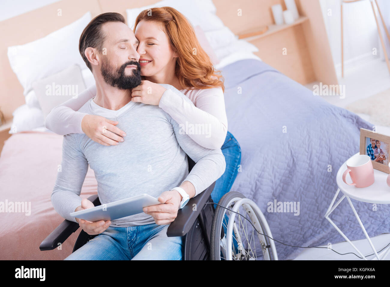 Content woman and disabled woman caressing each other Stock Photo