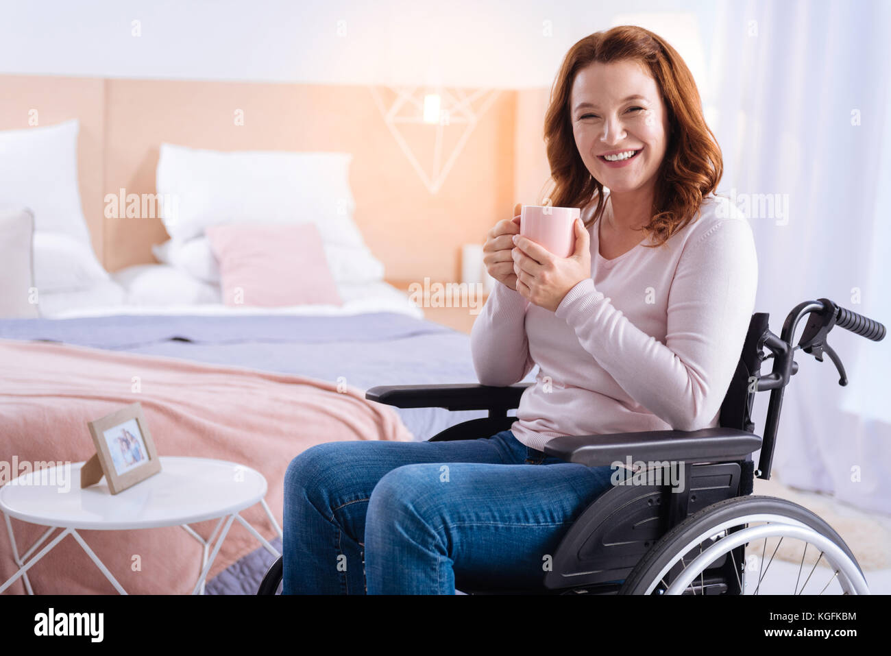 Laughing handicapped woman having tea Stock Photo