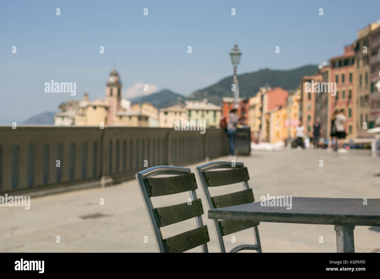 Bord walk of Camogli, Italy. Sitting outside a cafe looking at the montagnes and the palazzi beside the ocean. Stock Photo