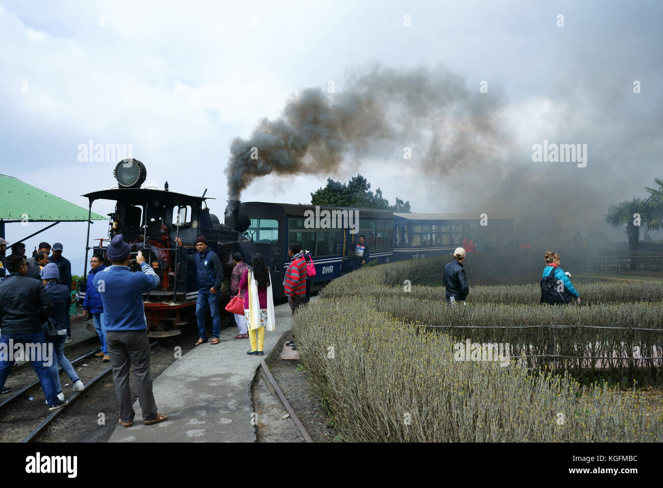 Tourists taking pictures of Toy Train at the loop, Darjeeling, West Bengal, India Stock Photo