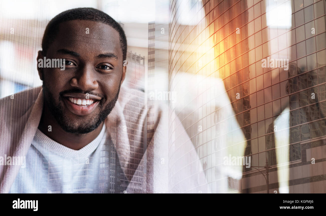 Handsome alert young man smiling Stock Photo - Alamy