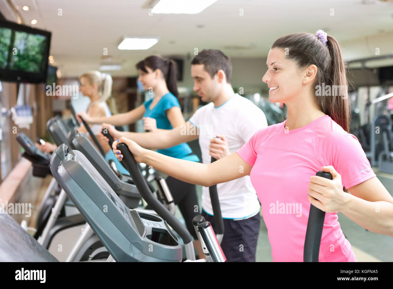 young people training on simulators in gym Stock Photo - Alamy