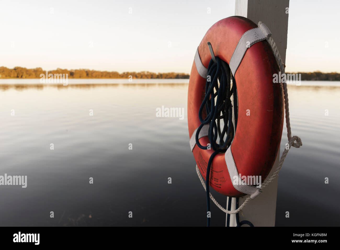 Life Perserver On A Boat Dock Near The Water Stock Photo