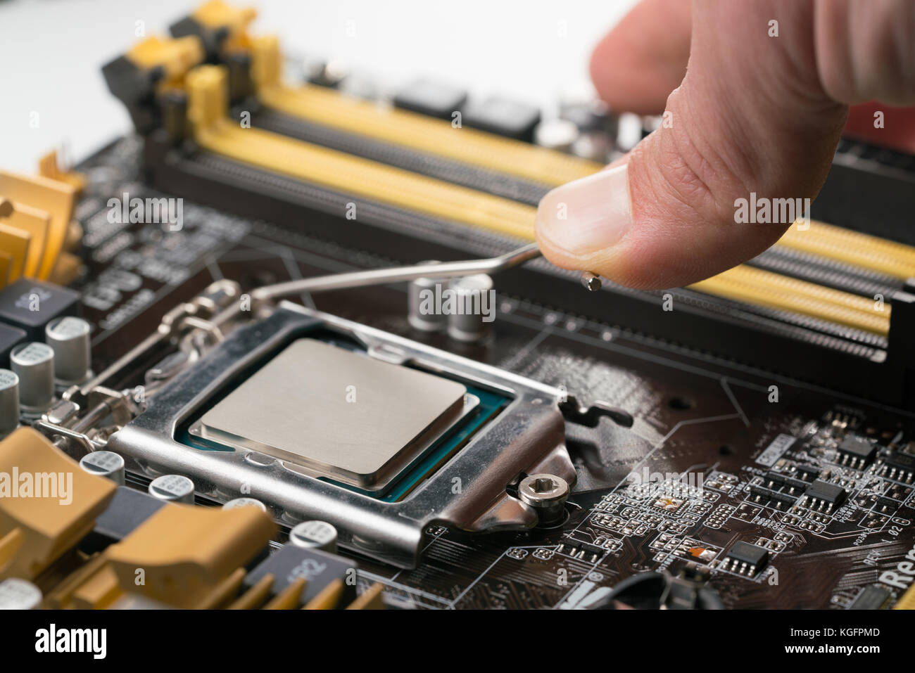 Technician plug in CPU microprocessor to motherboard socket Stock Photo