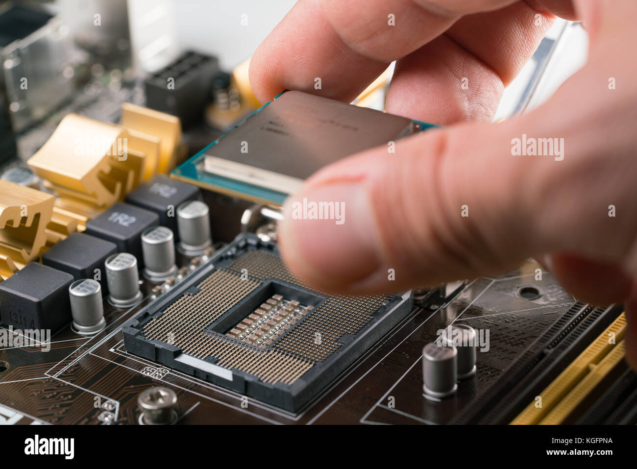 Technician plug in CPU microprocessor to motherboard socket Stock Photo