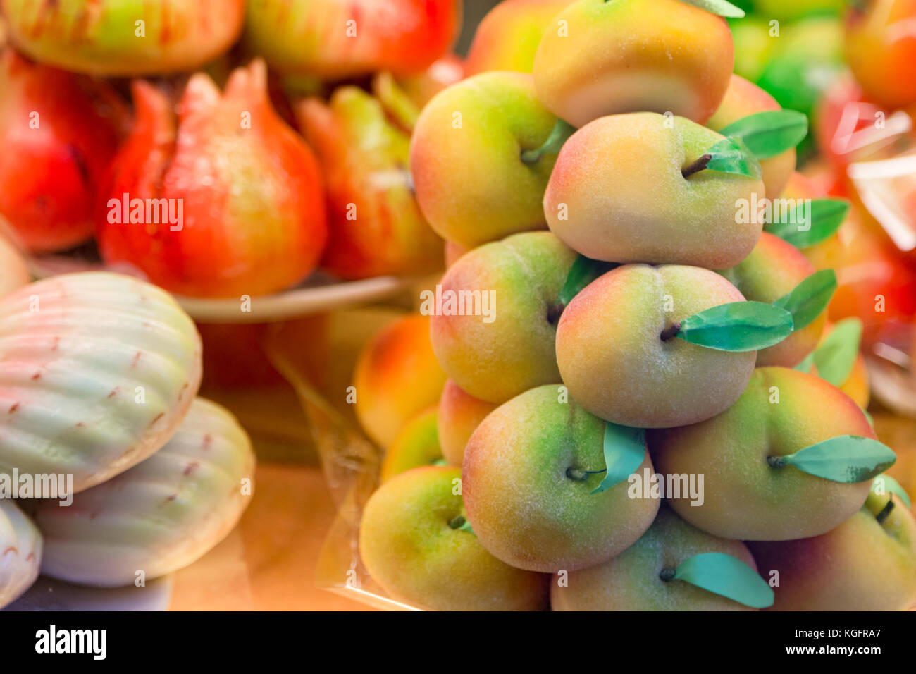 Cakes with marzipan in the form of peach. Stock Photo