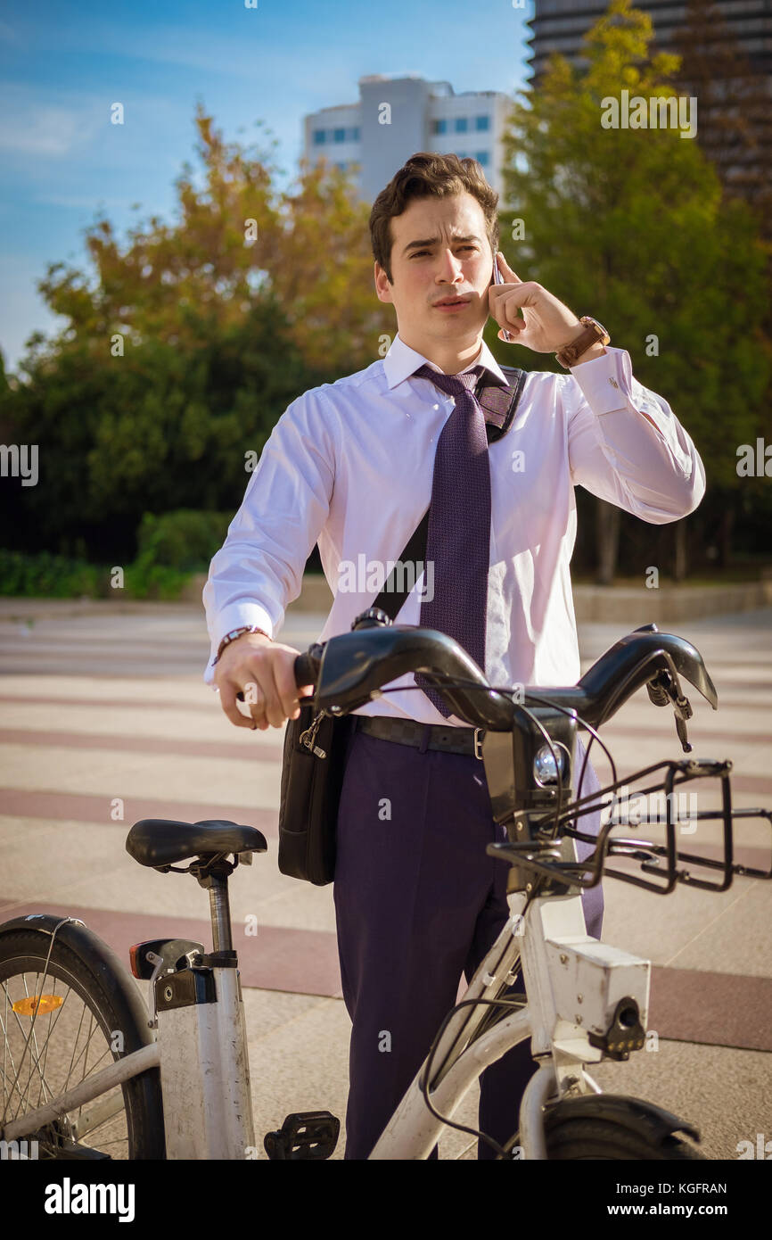 Young businessman riding a bike to work in the city Stock Photo Alamy