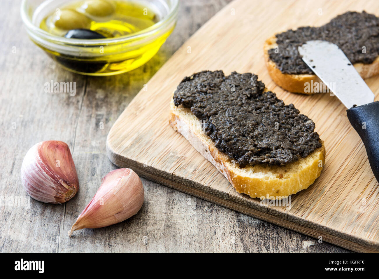 Black olive tapenade with anchovies, garlic and olive oil in toast on