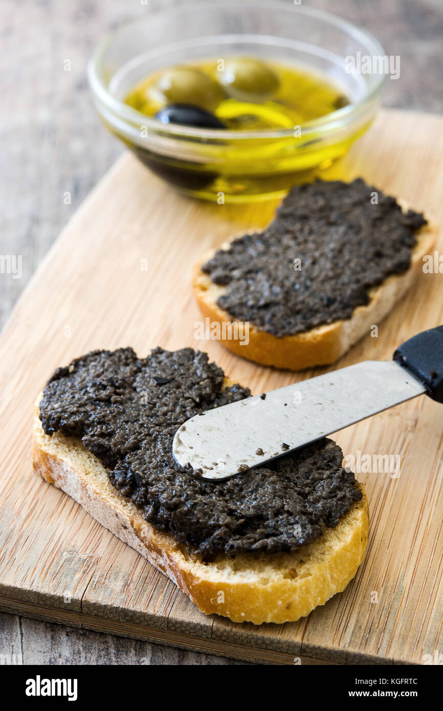 Black olive tapenade with anchovies, garlic and olive oil in toast on