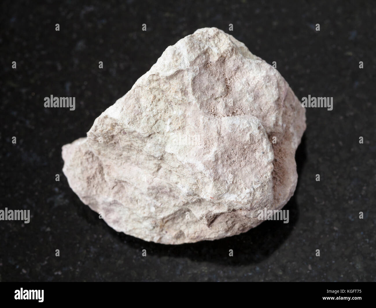macro shooting of natural mineral rock specimen - raw marl stone on dark granite background Stock Photo