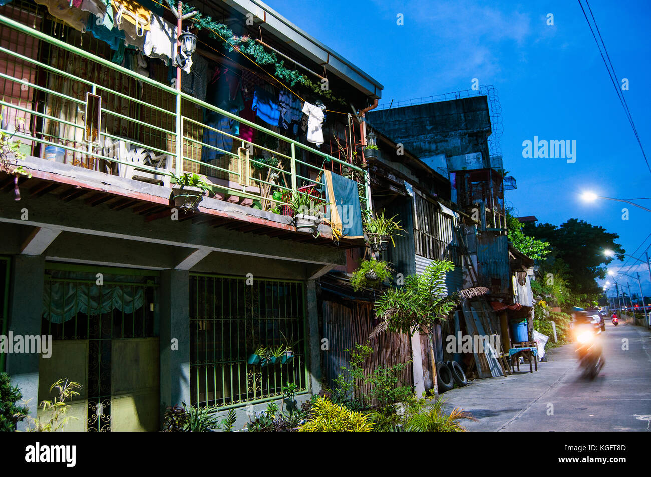 Housing along Naga River at dusk, Naga City, Camarines Sur,  Bicol, Philippines Stock Photo