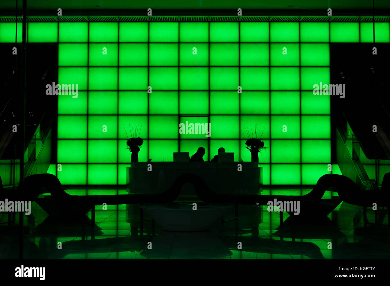 Green internal lights and people in shadows Stock Photo Alamy