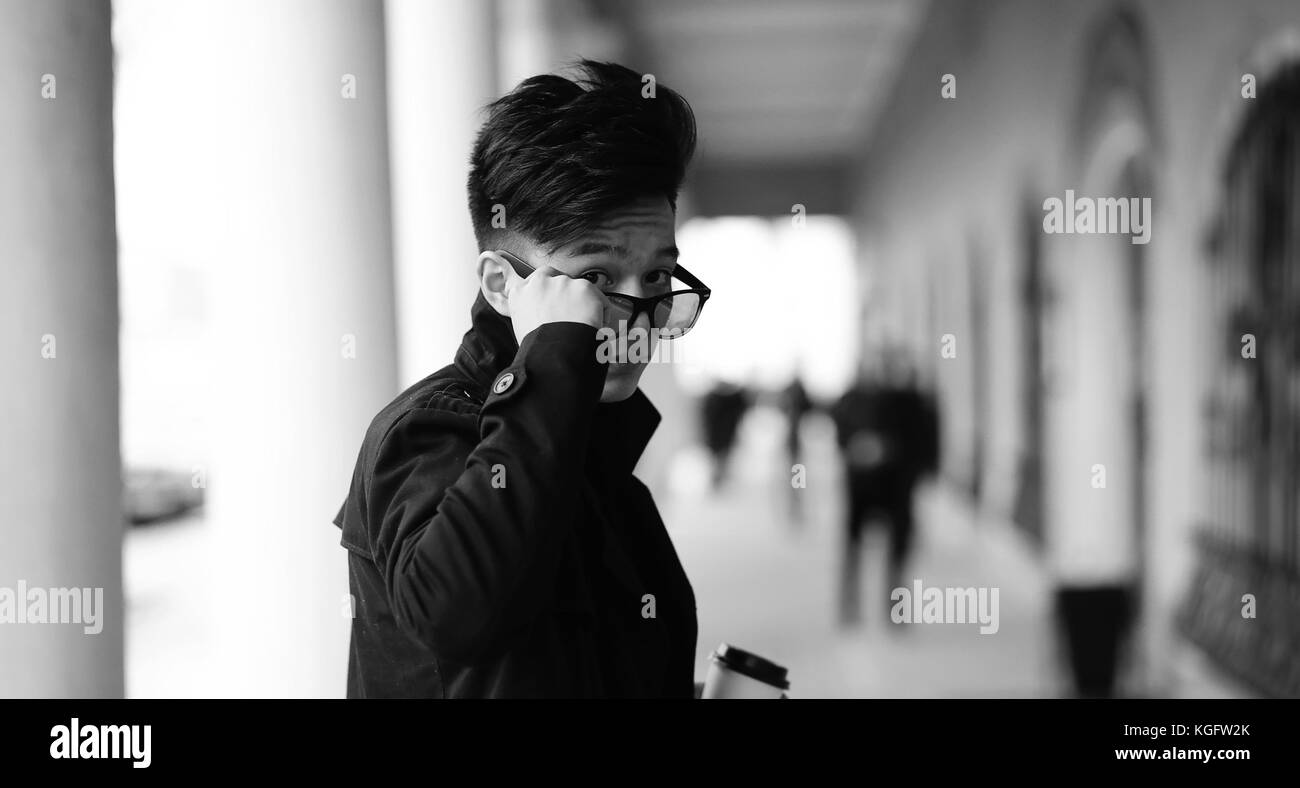 Black White photo of Asian young man outdoors posing Stock Photo - Alamy