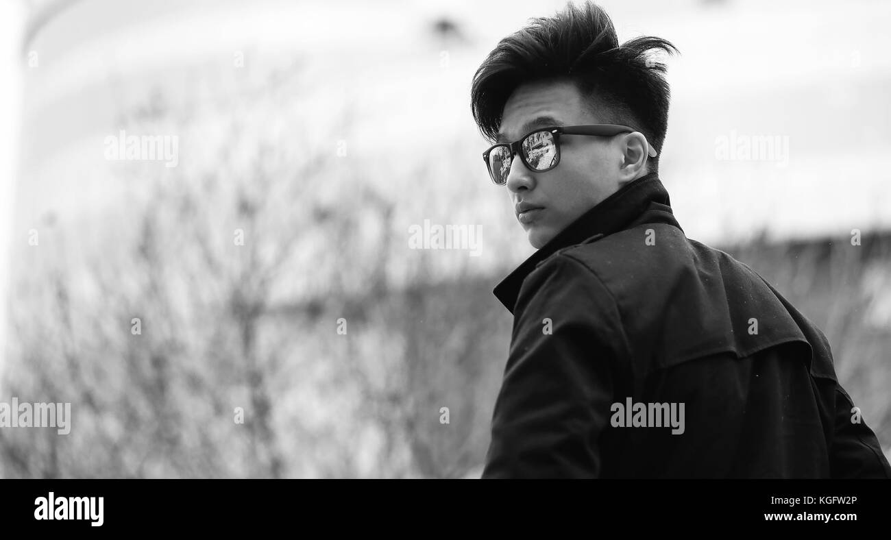 Black White photo of Asian young man outdoors posing Stock Photo - Alamy