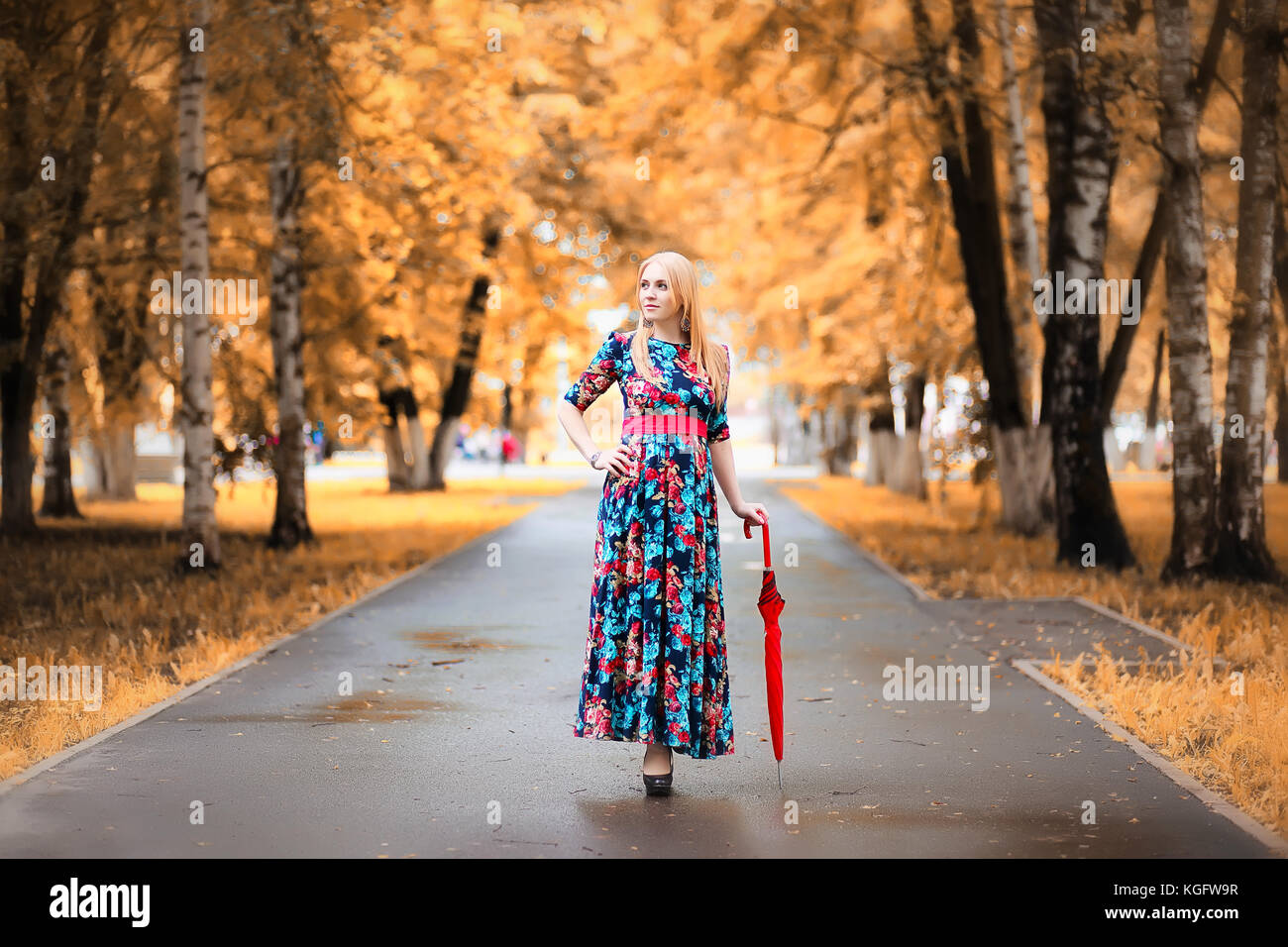 Girl in the street with an umbrella Stock Photo - Alamy