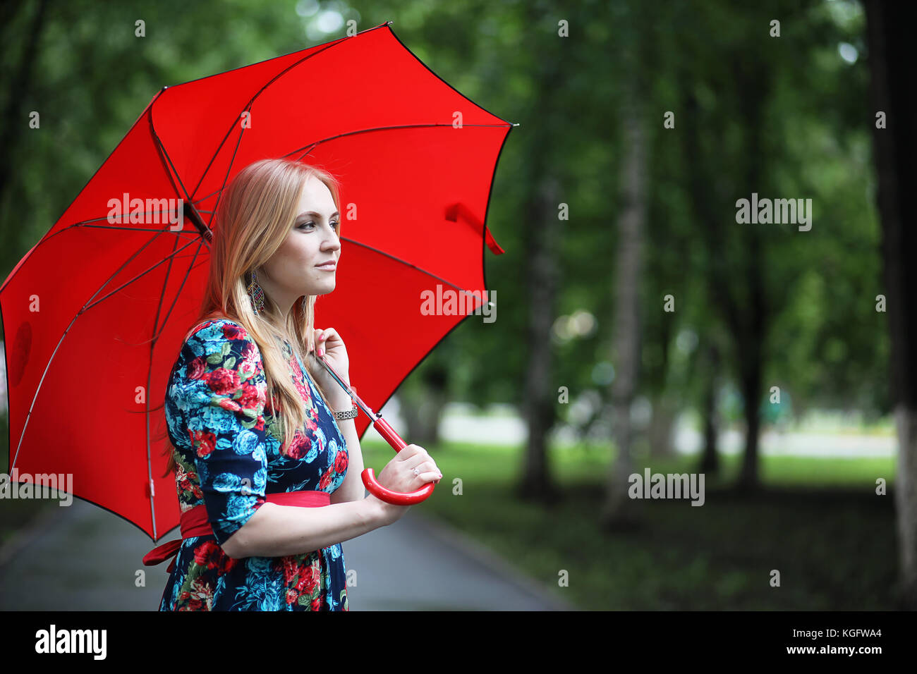 Girl in the street with an umbrella Stock Photo - Alamy