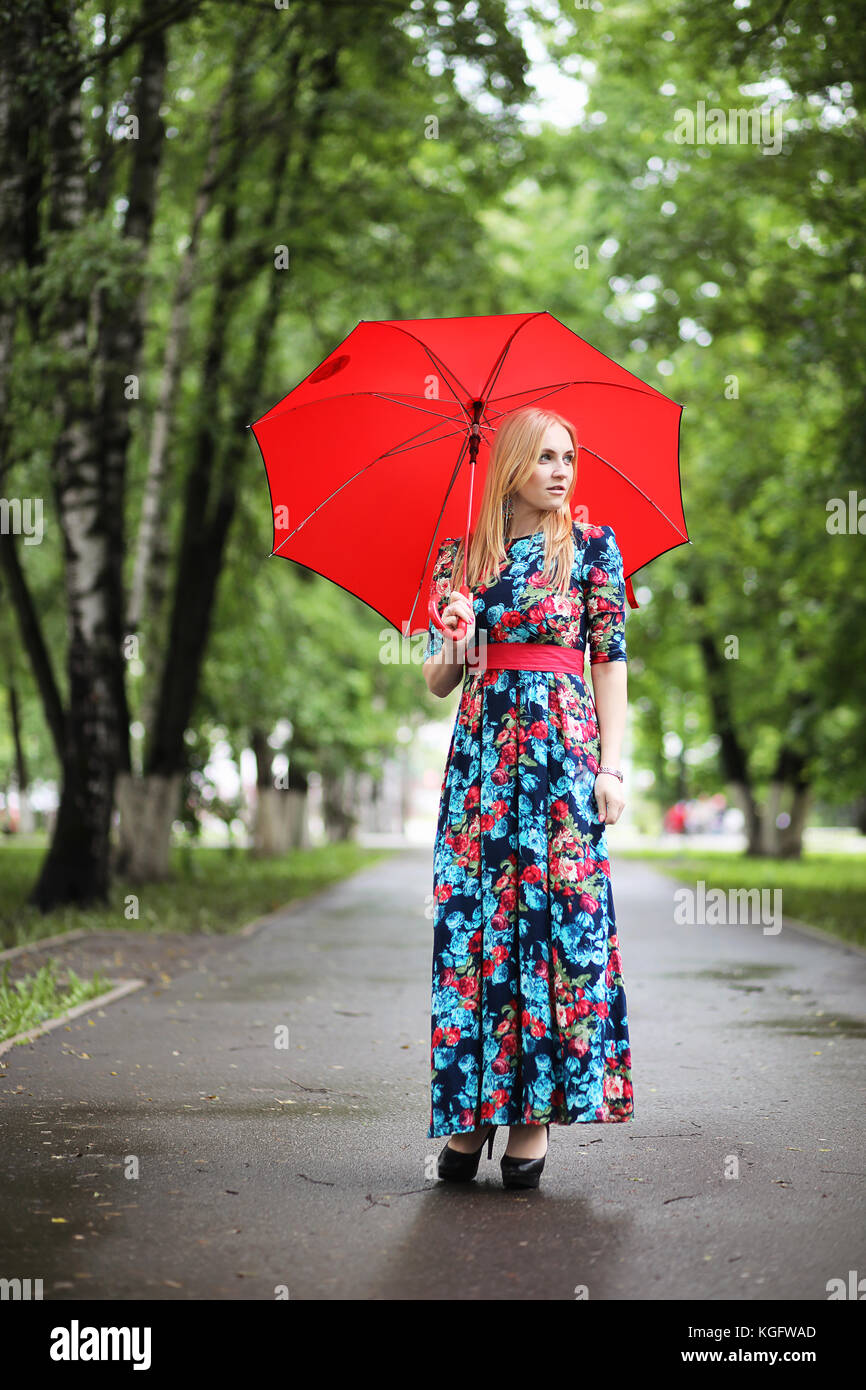 Girl in the street with an umbrella Stock Photo - Alamy