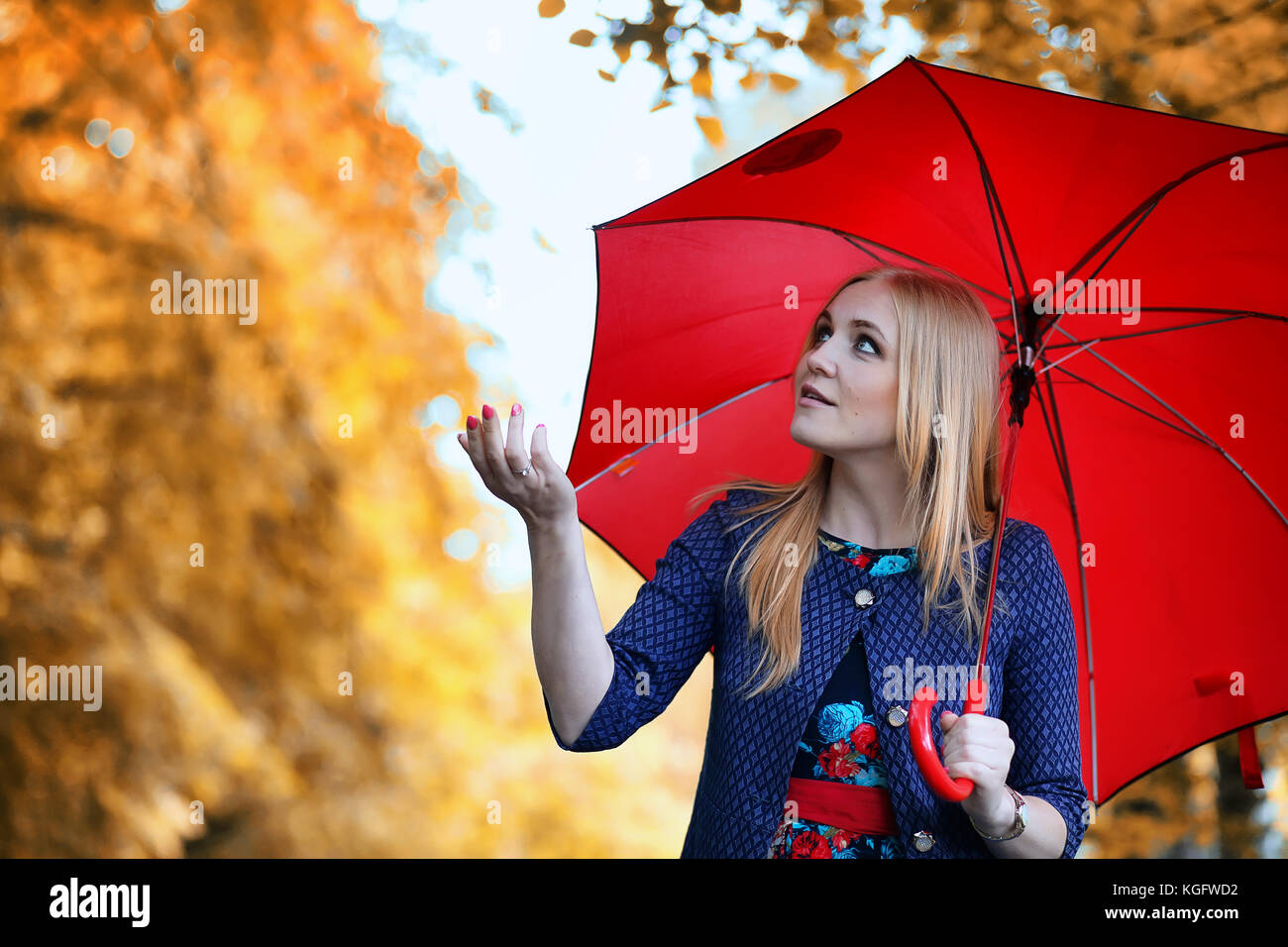 Girl in the street with an umbrella Stock Photo - Alamy