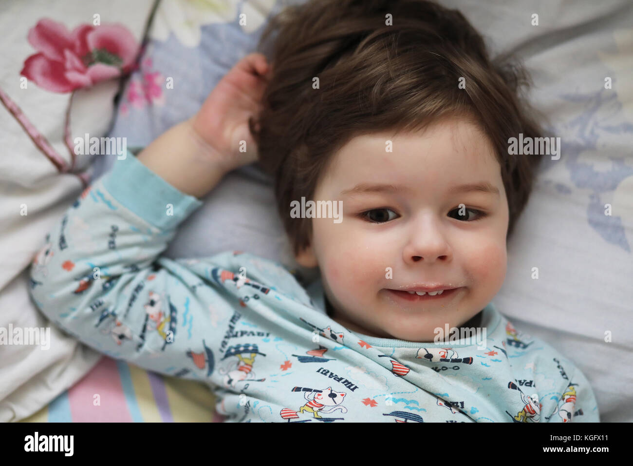 Portrait of a young child lying on a pillow Stock Photo Alamy