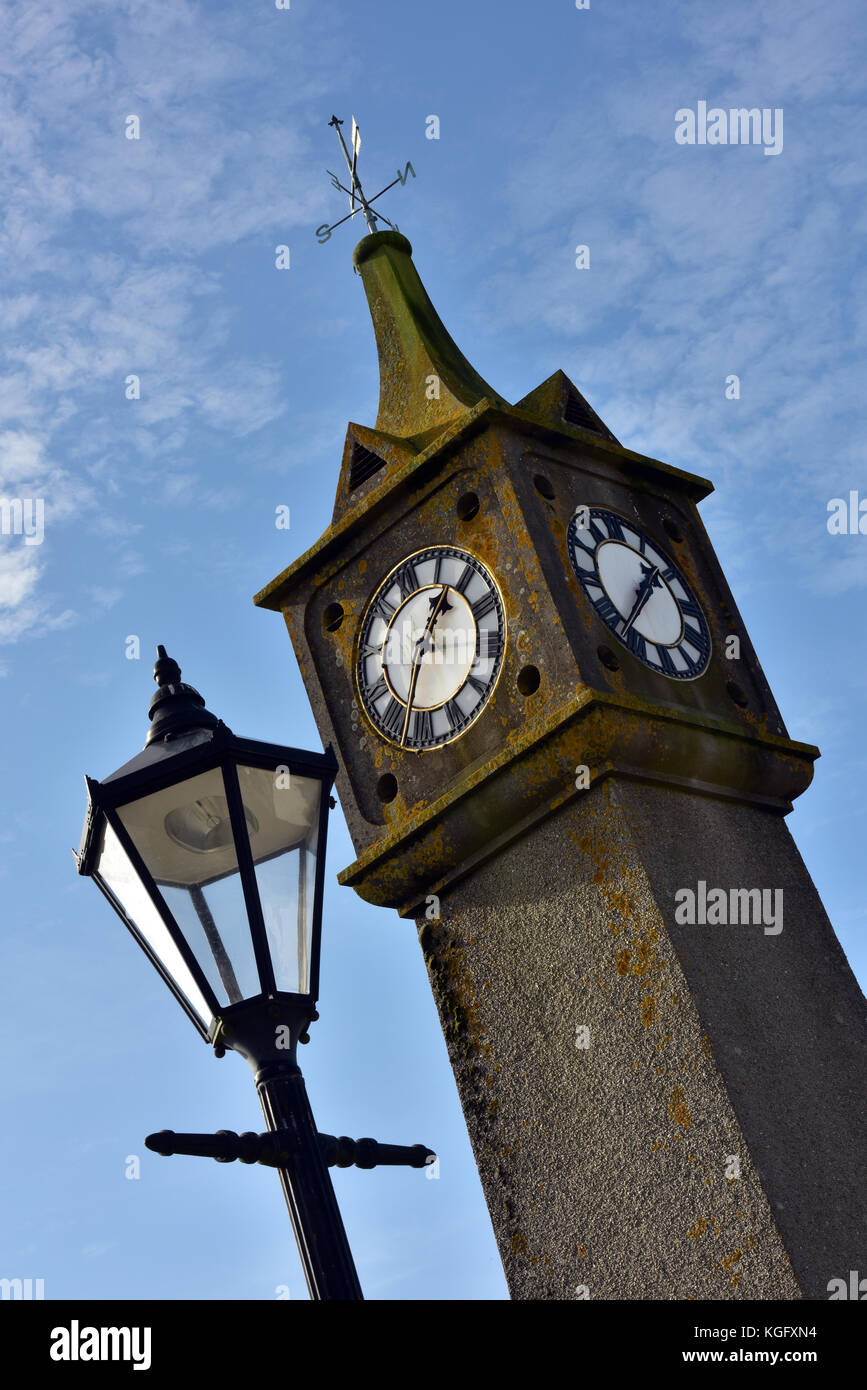 a lamp post and historical clock in the village square at saint just on ...