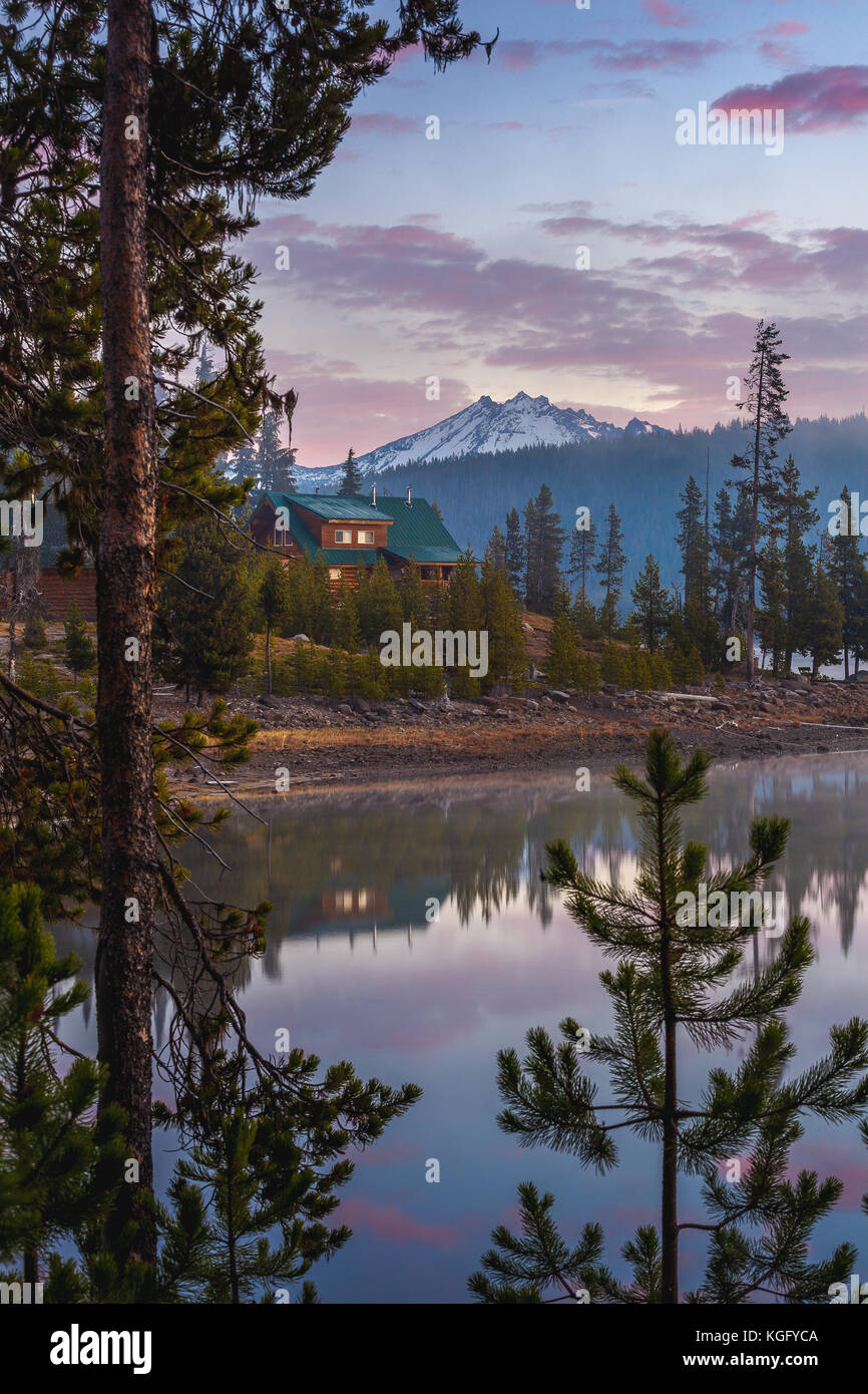 Broken Top Stands In The Background Of A Cozy Cabin On The Shore