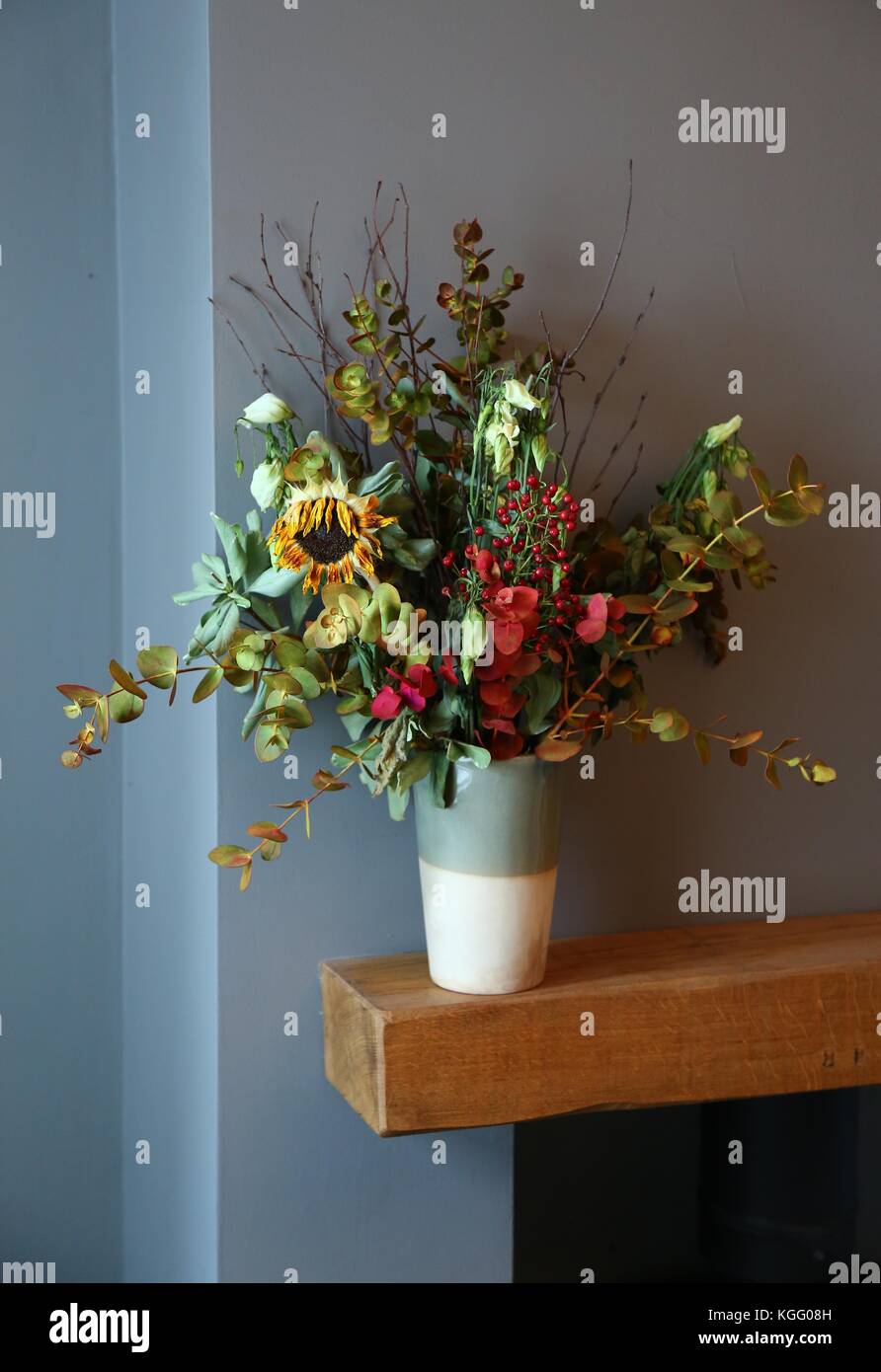 A vase of dead flowers including a wilted Sunflower Stock Photo Alamy