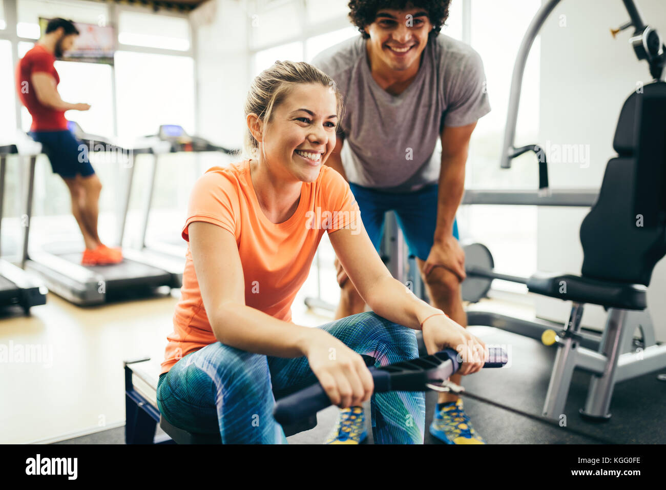 Young beautiful woman doing exercises with personal trainer Stock Photo