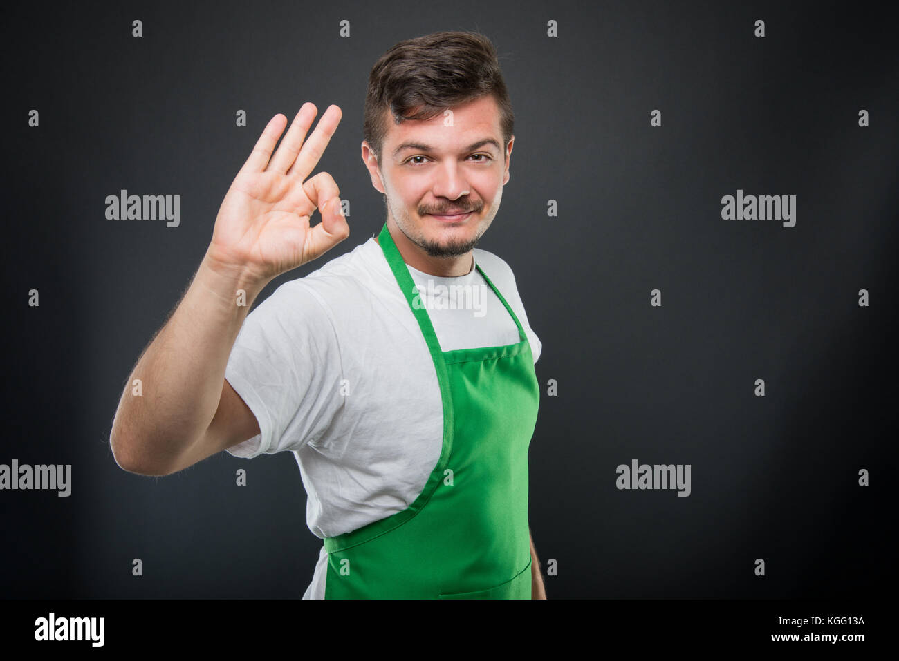 Portrait of attractive supermarket employer showing okay gesture on ...