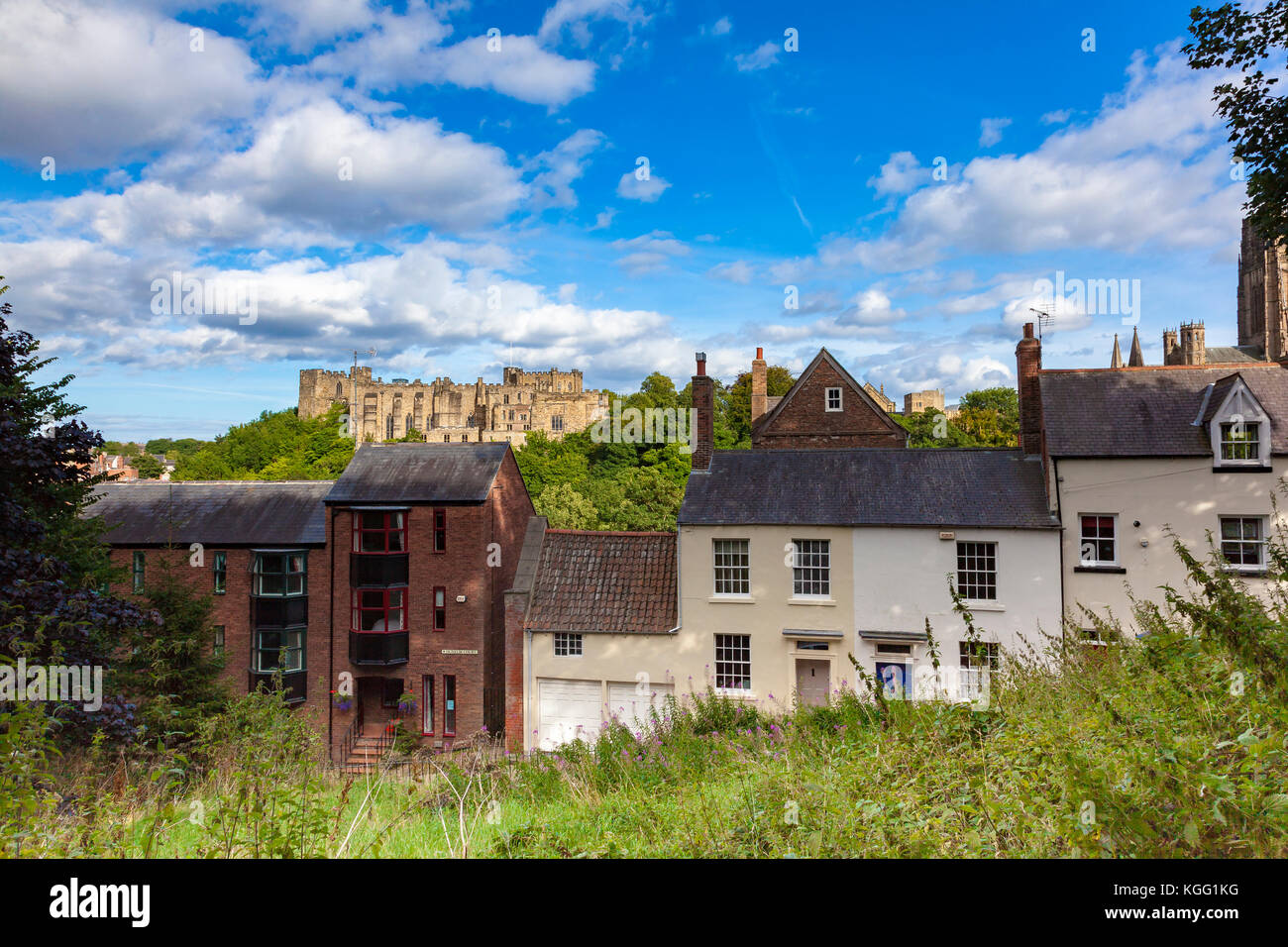 A view across South Street hill of Durham Castle, on the other side of the River Wear, with modern and historic cottages, County Durham, UK Stock Photo