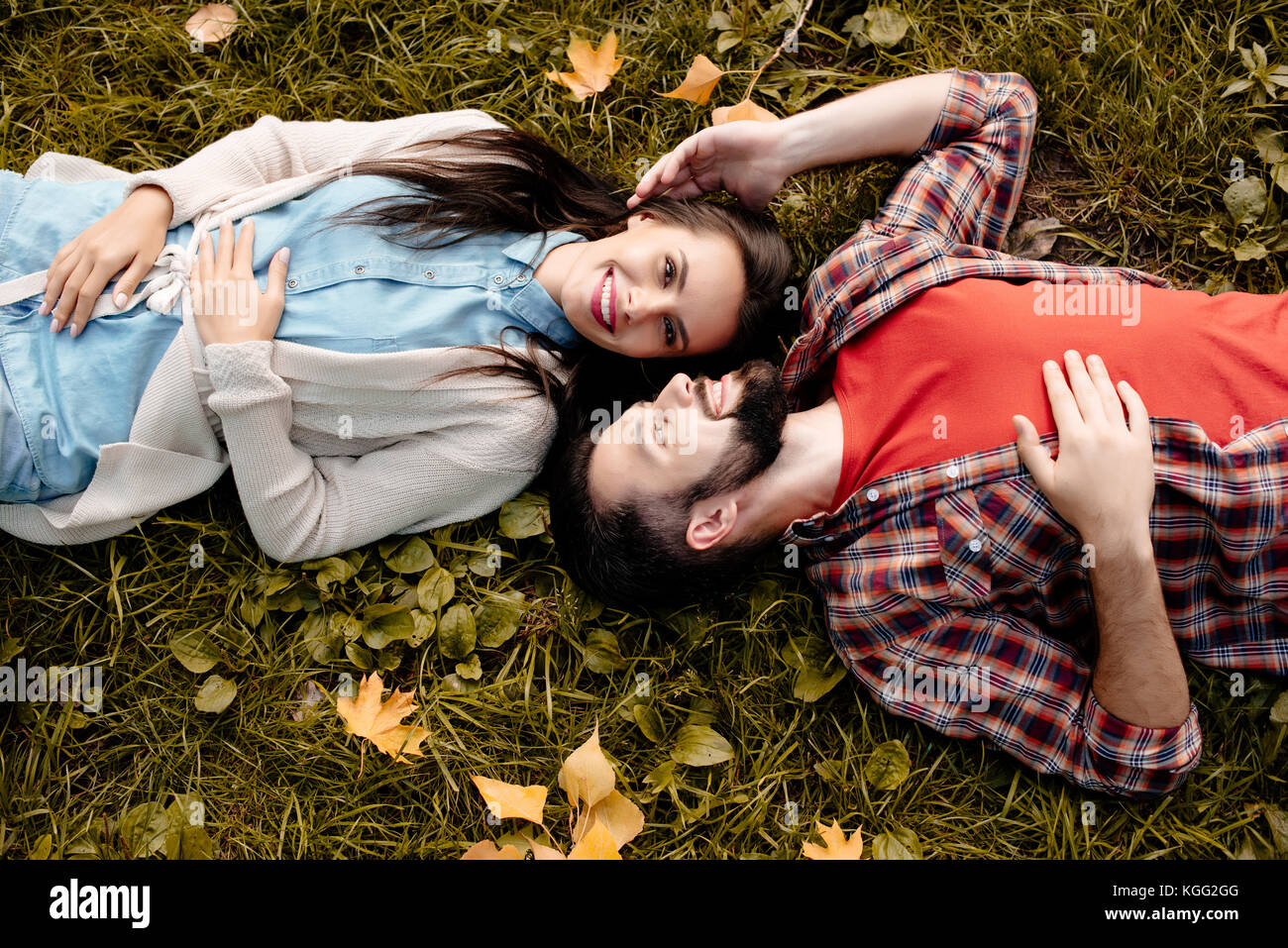 Young couple lying on grass hi-res stock photography and images - Alamy