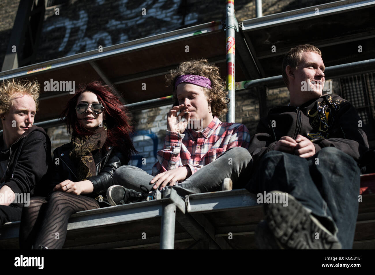 A group of 420 Day participants have climbed a scaffolding from where they enjoy the sun and the relaxed atmosphere around Christiania in Copenhagen. Denmark 20/04 2014. Stock Photo