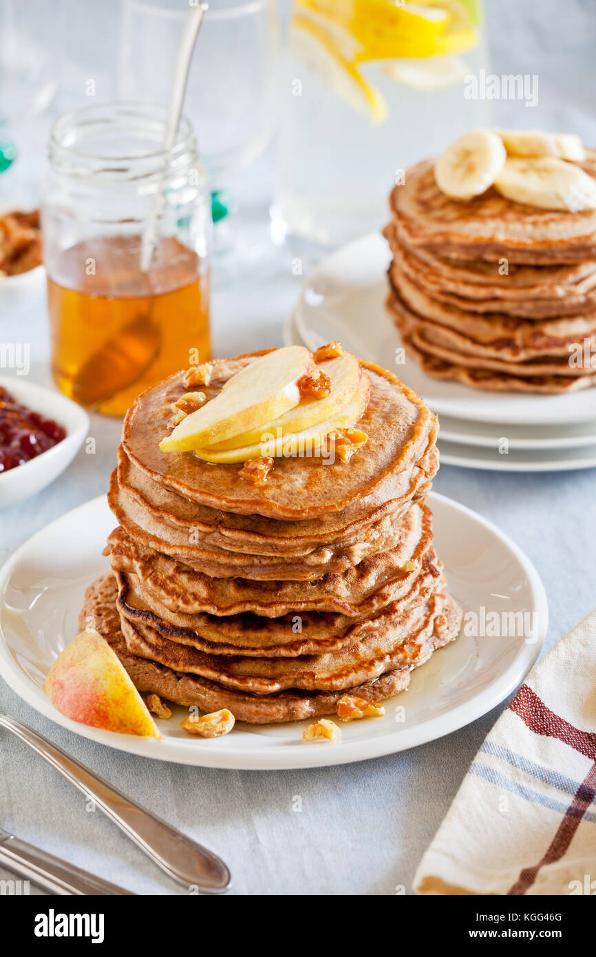 stack-of-homemade-whole-wheat-pancakes-with-fruits-and-nuts-stock-photo