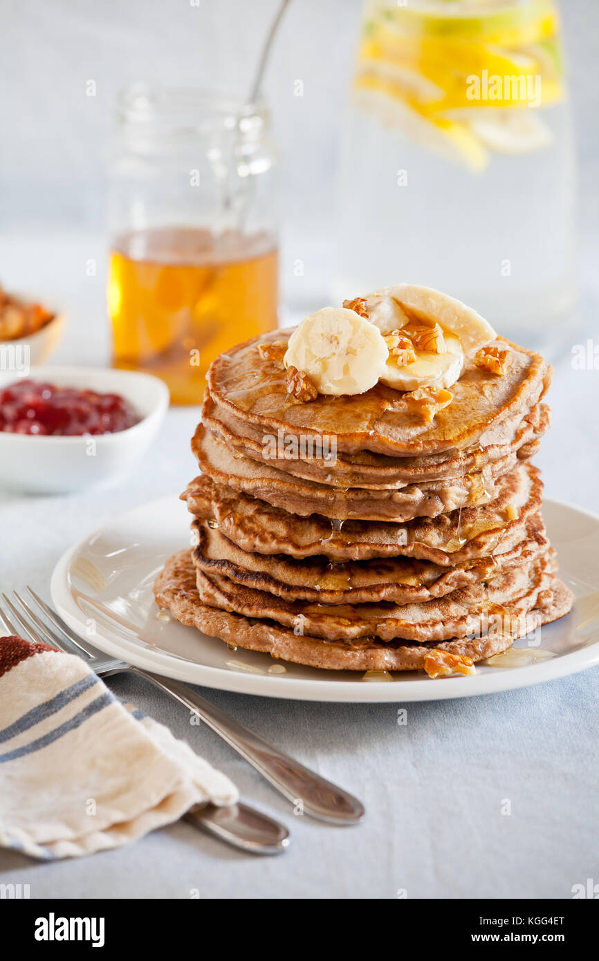 stack-of-homemade-whole-wheat-pancakes-with-fruits-and-nuts-stock-photo