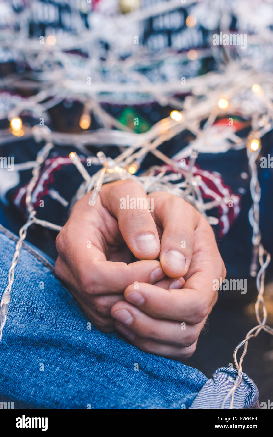 man tied up with christmas garland Stock Photo