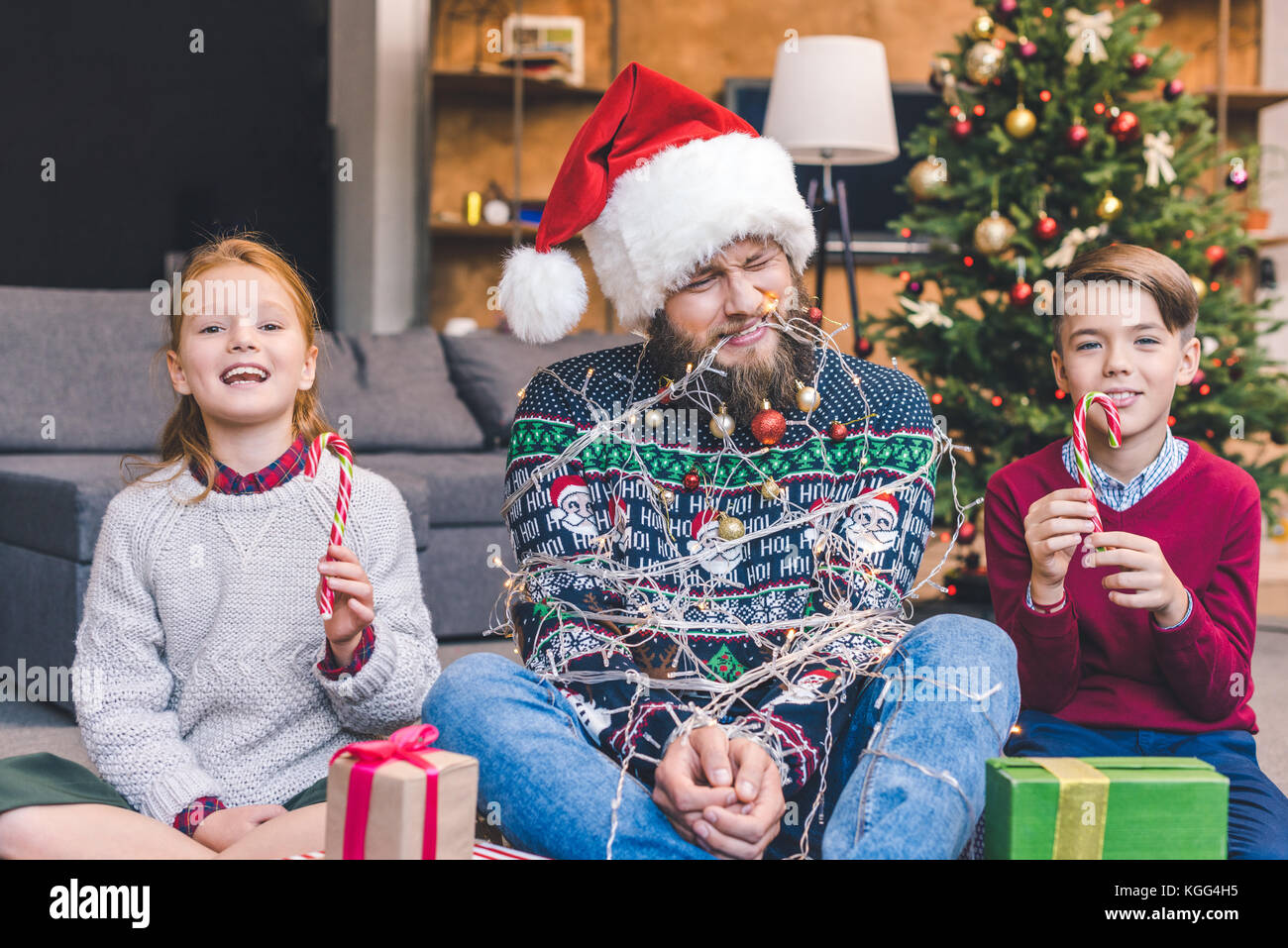 kids and father tied up with garland Stock Photo