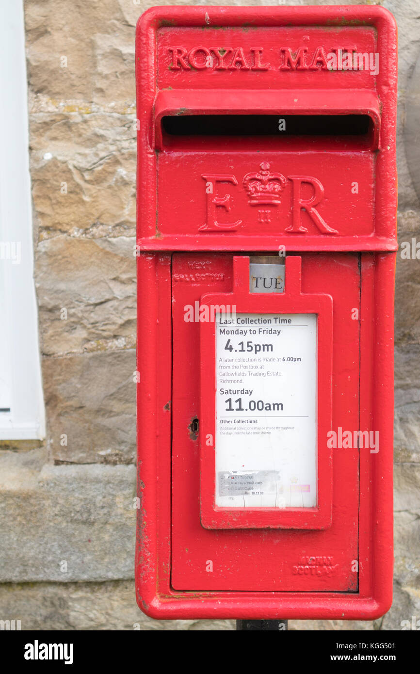 A traditional wall mounted red British post box built by Machan Engineering in Denny, Scotland. Stock Photo