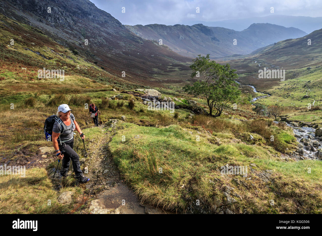Two walkers hiking up to  Greenup Edge from Far Easedale, Cumbria, England, Stock Photo