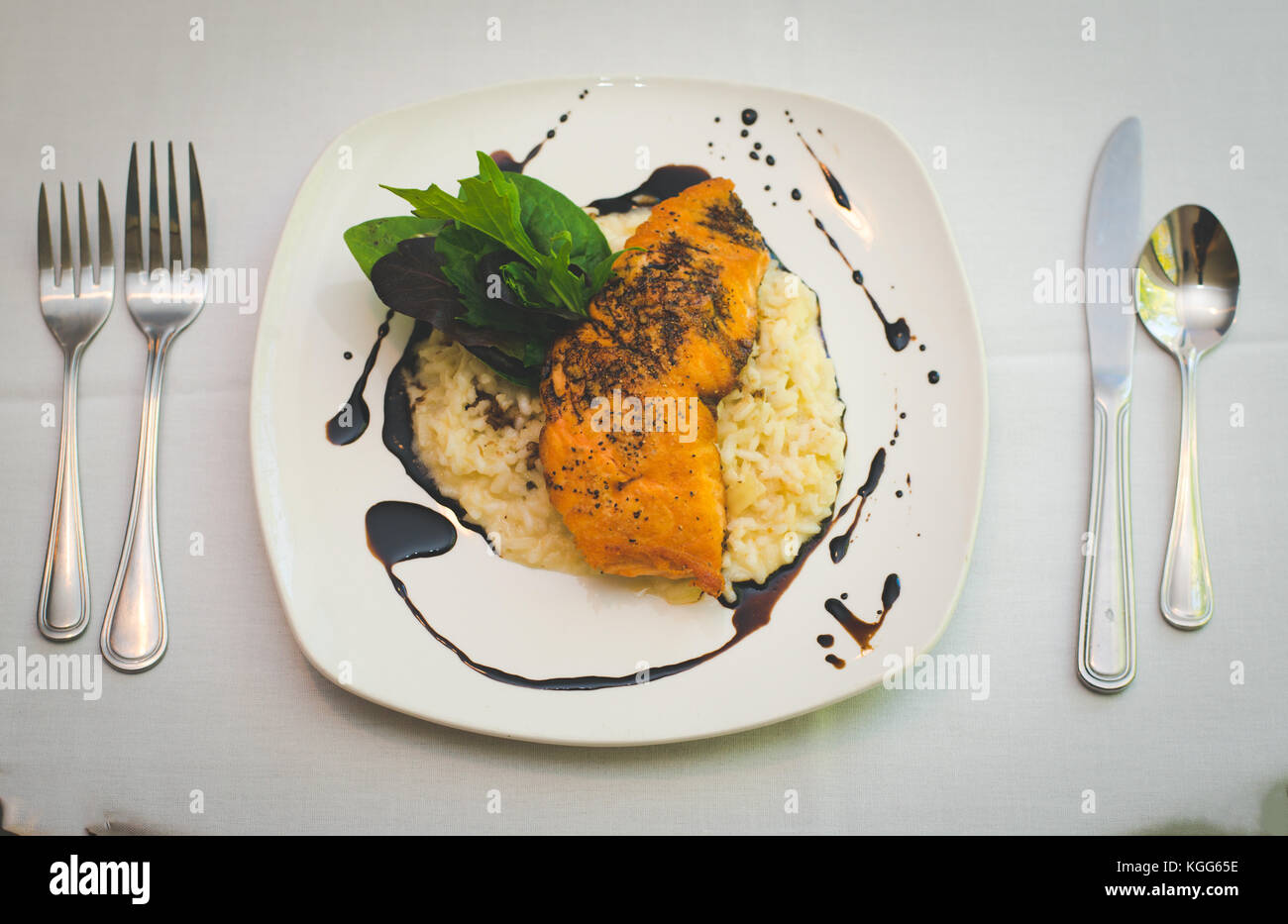 A salmon and rice dish presented plated at a restaurant. Stock Photo