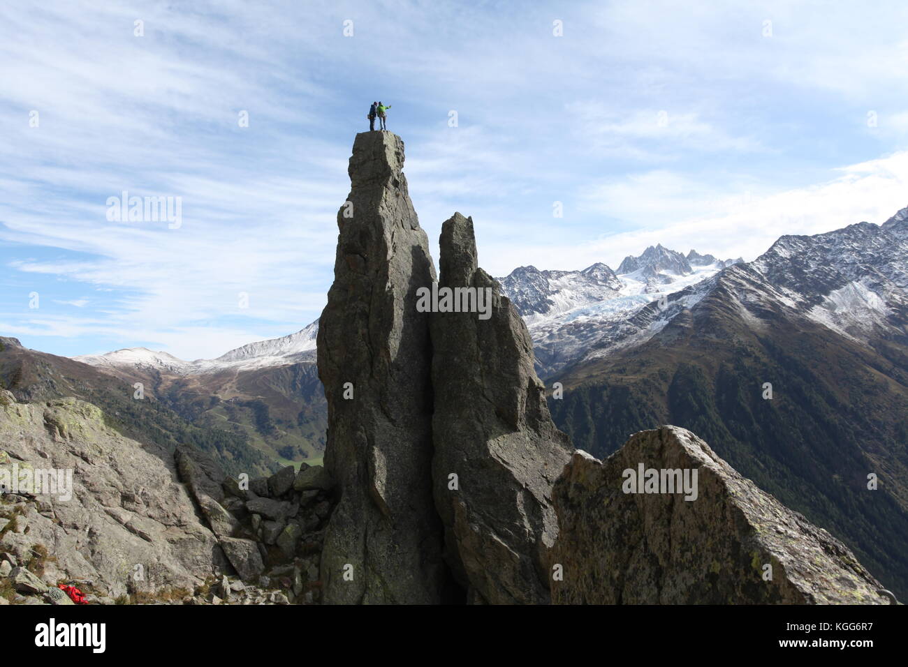 rock climbers on an extreme natural totem pole overlooking the magnificent views of the Mont Blanc in France Stock Photo