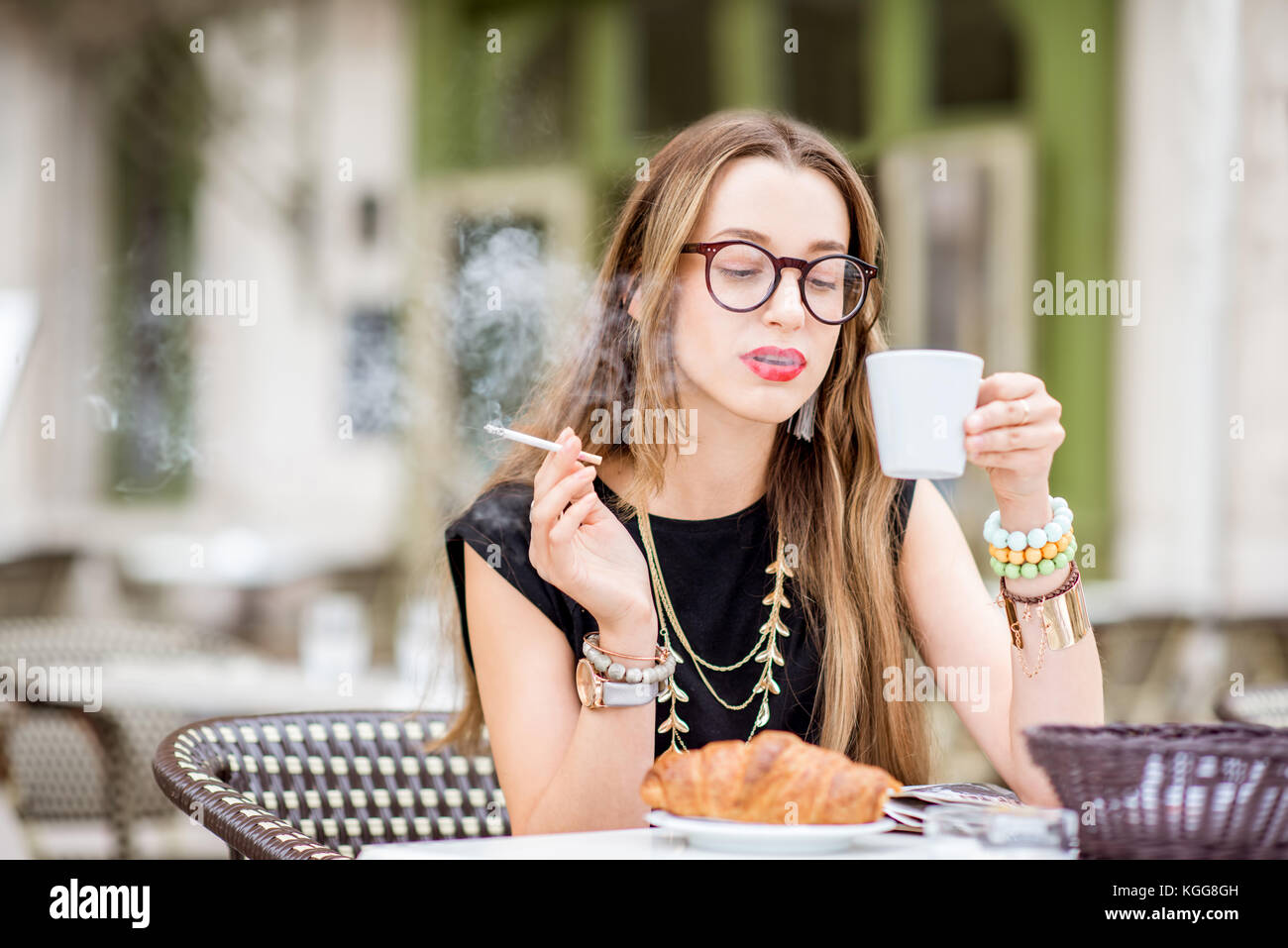 Smoking woman at the french cafe Stock Photo